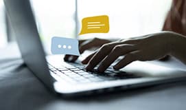 Woman using live chat chatting on application in laptop